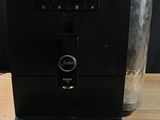 the coffee machine is sitting on the table ready to be used