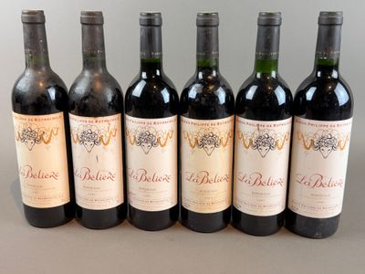 six bottles of wine are lined up in a row on a table
