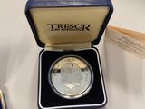 an image of a silver coin in a blue box on a table