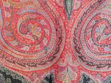 an image of a close up of a red and black paisley shawl