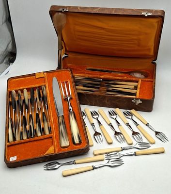 many different types of knives and spoons in a case