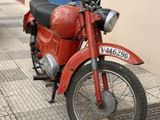 a red motorcycle parked on the side of the street