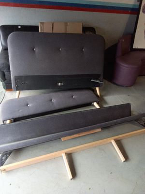 a bed frame that is sitting in the middle of a room