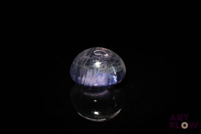 an image of a blue and white stone on a black surface
