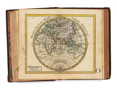 an old book with a map of the world on it