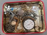 a red box filled with assorted jewelry on a table
