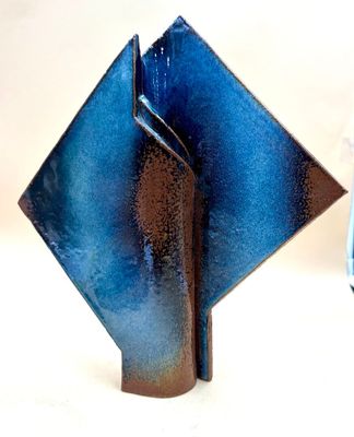 two blue vases sitting next to each other on a table