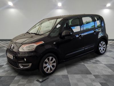 la petite voiture noire est garée dans le garage sur un sol en damier
