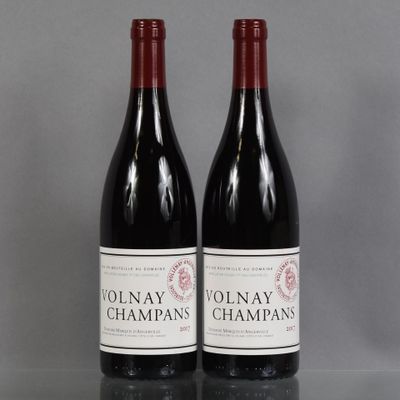 two bottles of red wine sitting on top of a table