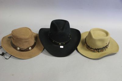 three hats are lined up on a white surface