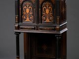 an antique wooden cabinet with a carved design on the front and sides