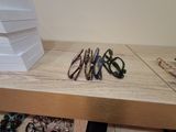 several pairs of glasses are sitting on a table next to a stack of books
