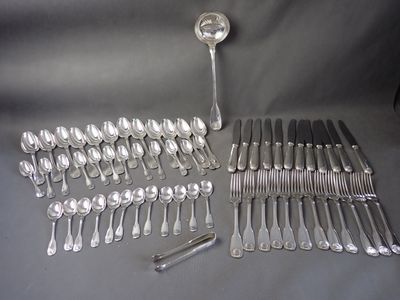 many spoons and forks laid out on a table