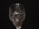 a wine glass sitting on a table with a black background