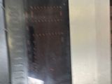 a silver refrigerator sitting in a kitchen next to a stove
