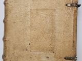 a close up of an old book on a white surface