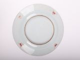 a white plate with a brown rim on a white table