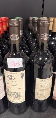 many bottles of wine sitting on a shelf in a store