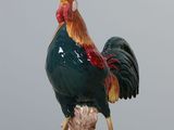 a figurine of a rooster on a wooden table
