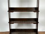 an old wooden book shelf on a parquet floor in a room