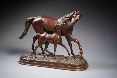 statue of two horses and a foal on a wooden base