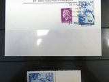 two stamps on display in a glass case on a black surface