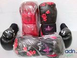 three boxing gloves wrapped in plastic bags on a table
