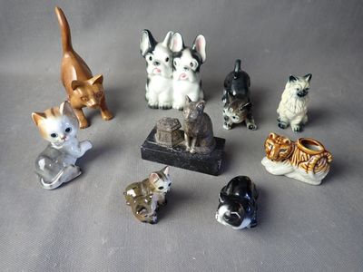 a lot of small figurines of cats on a table