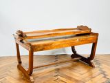 an old wooden bench sitting on top of a hard wood floor