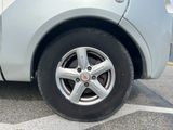 a close up of a car ' s tire on a parking lot