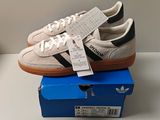 adidas gazelle trainers in white and black on top of a blue box
