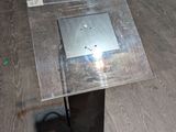 a table with a glass top on a wooden floor