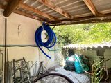 a hose hanging from the ceiling of a garage