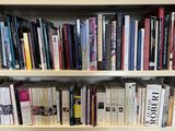 a bookshelf with many books on it in a room
