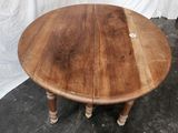 a wooden table with a wooden top on a black floor