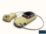 a toy car connected to a computer mouse on a white surface