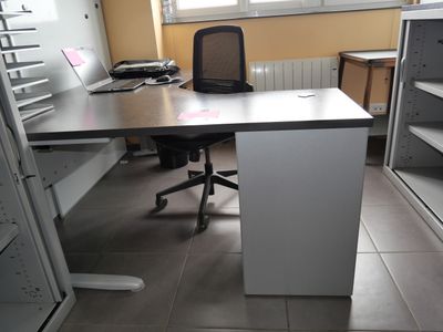 a desk with a chair and a computer on it