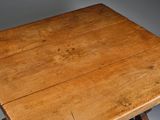 a wooden table with a wooden top on a gray background