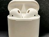 a pair of airpods sitting in a case on a black surface