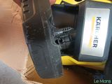 a person holding a yellow and black tool in a box