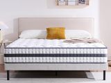a white bed sitting on top of a wooden floor next to a white wall