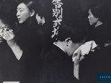 black and white photograph of a group of people eating food