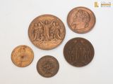 four different types of coins are shown on a white surface