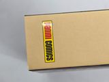 someone is holding a box with a yellow sticker on it