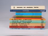 books stacked on top of each other on a white surface
