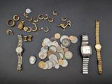 a lot of coins and a watch on a table