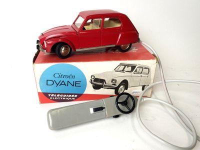 a red toy car that is sitting on top of a box