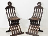 paire de chaises pliantes anciennes en bois avec des détails en métal