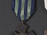 two medals and a cross on a black background