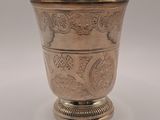 an antique silver cup on a pedestal with a silver base